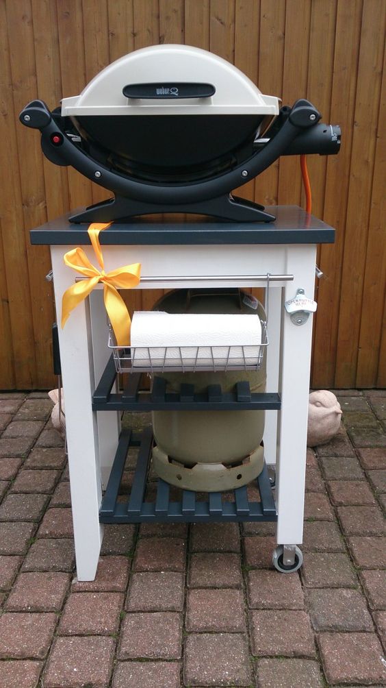 an IKEA Bekvam cart renovated into a grill table, painted black and white, with holders and hangers is a lovely idea