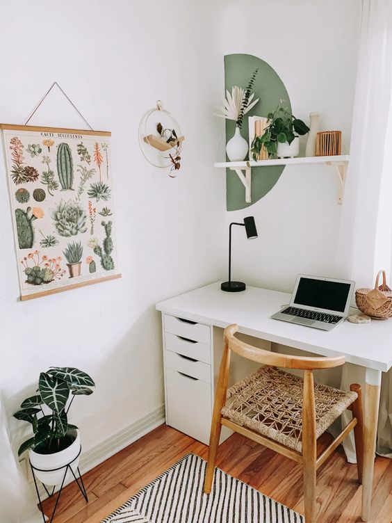 18 a small mid-century modern space with a white desk with drawers, a wooden chair, a shelf with vases, a boho poster and potted plants