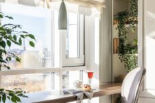 a cozy breakfast bar with built-in shelves, a vintage chair, a pendant lamp and a lovely view of the city