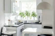 a light-filled white Scandinavian kitchen with black countertops and fixtures, a breakfast bar, a black and white stool