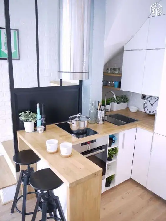 a modern farmhouse kitchen with sleek cabinets, butcherblock countertops, a breakfast bar with tall black stools