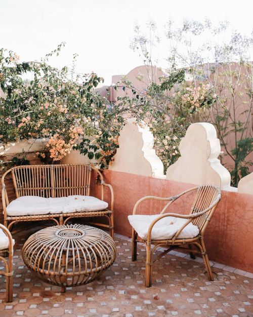 classic outdoor rattan furniture with neutral cushions and a side table or ottoman will never go out of style and will match many spaces