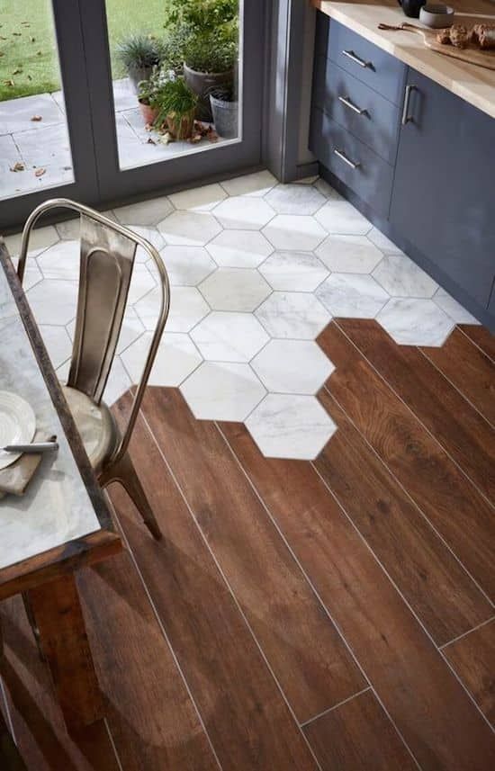 a chic transitional floor with rich stained laminate and white marble hexagon tiles is a very chic and bold idea