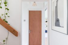 a small corridor with a cork floor and the same cover on the staircase is a chic idea that feels warm and natural