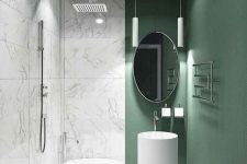 03 a gorgeous minimalist bathroom with white marble tiles and a green accent wall that brings this space to life