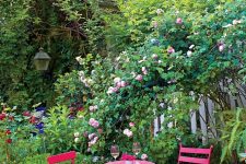 04 a small and cozy backyard with grass, with a hot pink outdoor dining set, with lots of blooming branches and blooms is cool