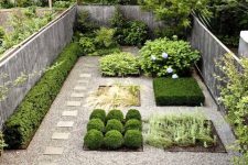 07 a small backyard with mini flower beds with different types of plants and gravel and tiles around is pure modern elegance