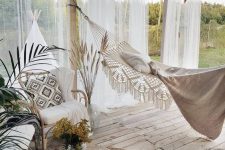 13 a breezy outdoor boho deck with a pergola, some rattan furniture, a jute pouf and jute rugs, a hammock and paper lamps