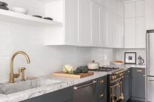 15 a stylish grey and white kitchen with a white subway tile backsplash, a white stone countertop and a hood hidden in a cabinet is super chic