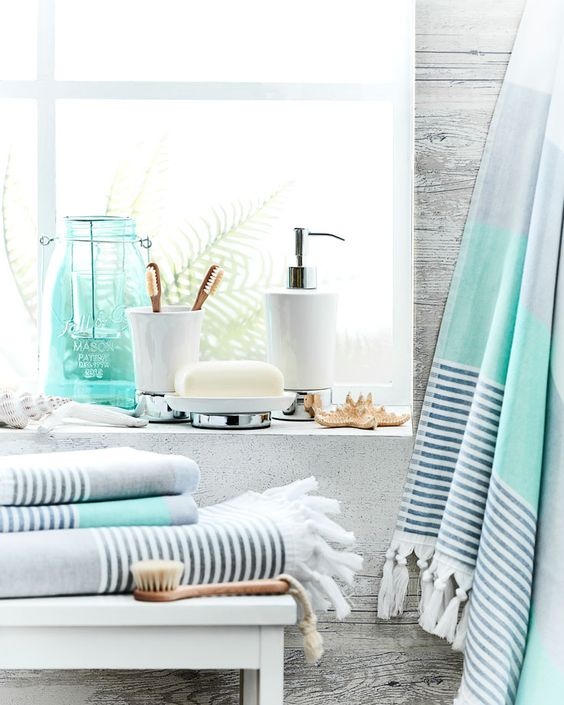 cool coastal themed grey, aqua and striped towels will make your bathroom feel like coasts and summer easily