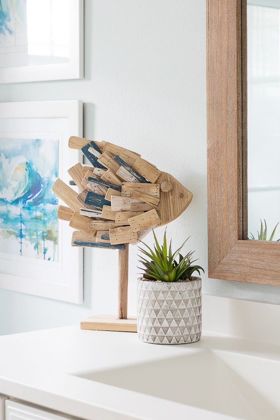 a cool coastal decoration - a fish made of reclaimed wood is a cool and fresh idea to bring a coastal feel to the bathroom