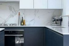 25 a sophisticated minimalist kitchen with white and navy cabinetry, a white marble backsplash and white countertops is amazing