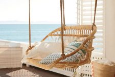 29 a suspended rattan chair with lots of pillows is always a good idea and it will easily match almost any outdoor space