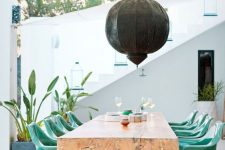 a stylish wooden table that is perfect for an outdoor dining space
