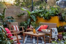 a bright tropical terrace with a mosaic tile floor, cane and wood furniture, bright pillows, lanterns over the space and tropical plants
