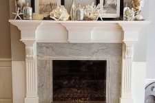 a coastal mantel with starfish and seashells, with black and white artworks and large jars with seashells feels very beachy
