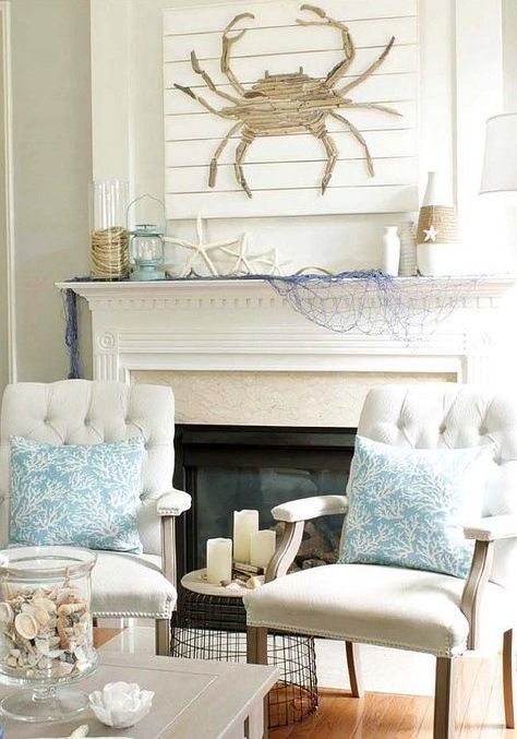 a cute rustic coastal mantel with a driftwood crab artwork, starfish, blue net, vases wrapped with rope and a candle lantern