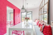 a dining room with a pink brick wall