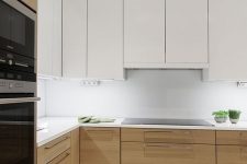 a minimalist kitchen with stained and white cabinets, a white backsplash and countertops plus built-in lights is amazing