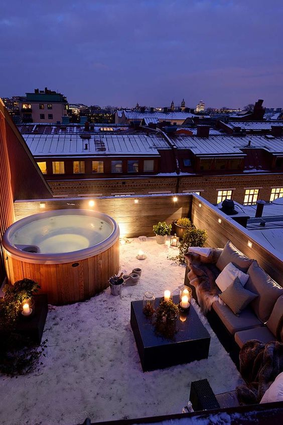 a rooftop terrace with a hot tub