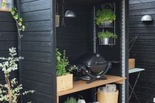 a small and cozy Scandinavian kitchen with a wooden unit covering shelves with a grill and some garden herbs is a genius idea