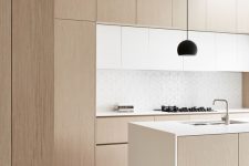 a sleek minimalist kitchen that combines whites and light wood