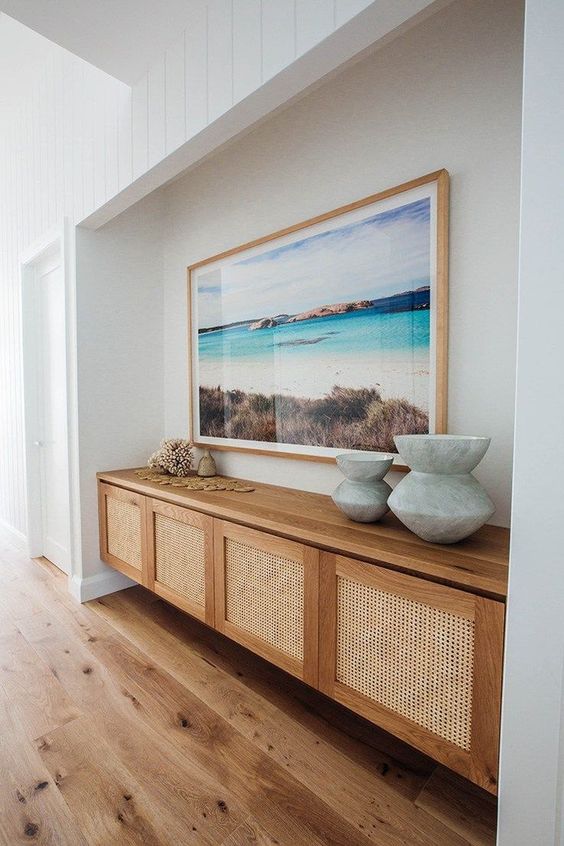 a beautiful floating credenza with cane doors is a stylish idea that matches a coastal space perfectly and looks amazing