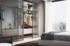 a contemporary bedroom done in grey and black, with light-stained wood, and with a closet with black wood slab sliding doors is cool