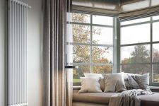 a cozy, neutral room design with large windows