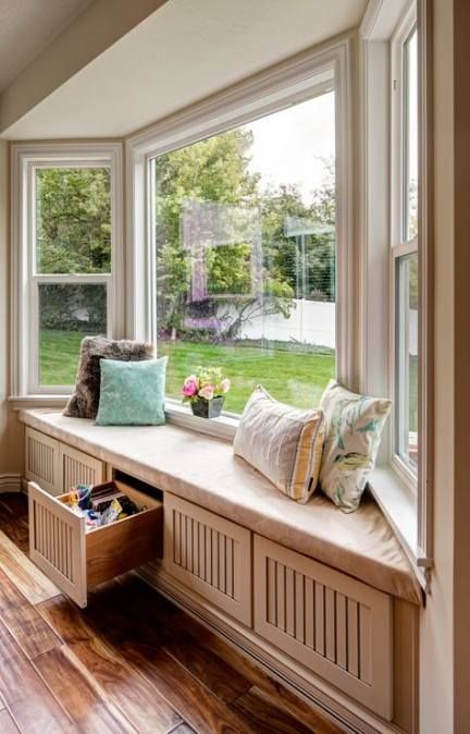 a cool bow window with a windowsill daybed and storage drawers inside plus colorful pillows is a cool idea for any home