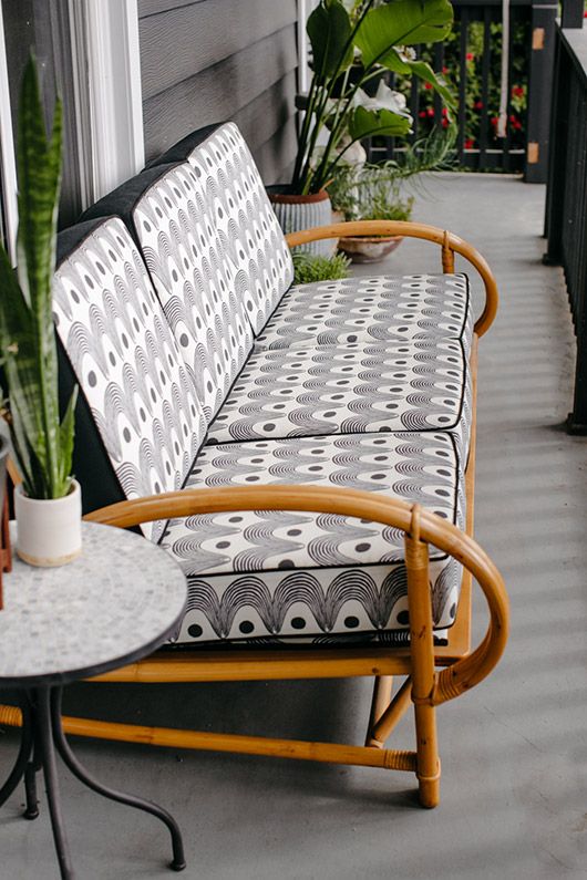 a cool modern outdoor sofa of bamboo and with printed cushions in black and white is a cool and fresh idea