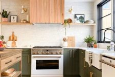 a cozy mid-century modern kitchen with green cabinets, light-stained shelves, a hood, white countertops, a wooden kitchen island