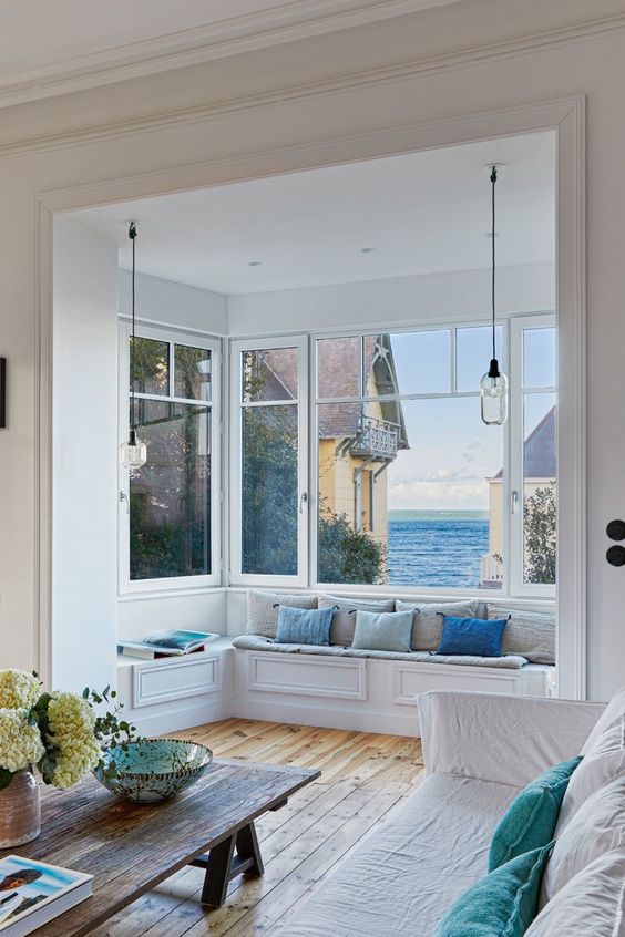 a gorgeous bow window with an upholstered built in bench and a fantastic view of the sea is amazing
