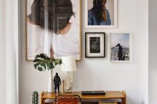 a modern gallery wall with cool pictures in a home office nook