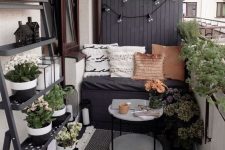 a tiny cozy balcony design with lots of greenery