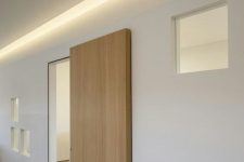 a modern light-stained sliding door is a very stylish and sleek idea for a contemporary or minimalist space