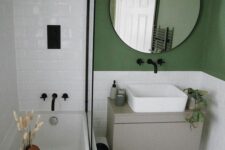 a modern bathroom with a green accent wall