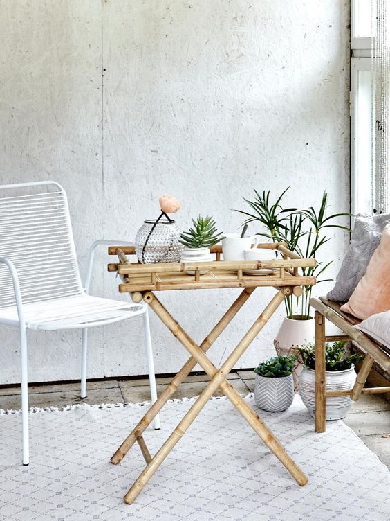 a small bamboo folding table is a great idea for an indoor or outdoor space, it can be folded any time