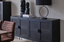 a sophisticated modern black buffet with cane doors is a fresh and modern take on thos traditional pieces that looks edgy
