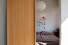 a stylish modern light-stained plywood sliding door is a beautiful solution for a modern or Scandinavian space and it looks eye-catching