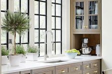 an elegant farmhouse kitchen with gold knobs, chromatic fixtures and appliances is a very elegant idea and the kitchen looks veyr cohesive