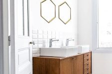 an elegant mid-century modern bathroom with white square tiles and black and white mosaic tiles on the floor, a stained vanity