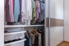 modern glass and plastic sliding doors keep the closet hidden and declutter the space this way making it sleek and cool