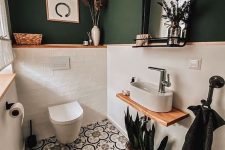 17 a small and chic powder room with green walls and white tiles, pretty Moroccan tiles on the floor, white applainces and some potted plants