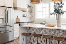 26 a beautiful farmhouse kitchen with white cabinets and a kitchen island accented with Moroccan tiles, woven pendant lamps, wooden stools and white tiles on the walls