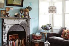 a cute blue living room with a non-working fireplace