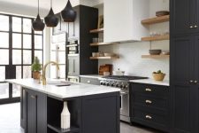 a chic black kitchen with shaker cabinets, white stone countertops, floating shelves and a white subway tile backsplash