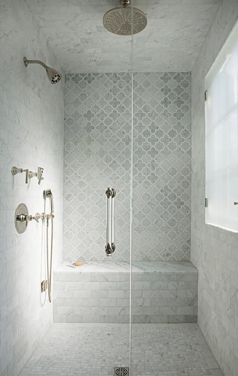 a chic shower space clad with white marble and marble arabesque tiles looks vintage-inspired and very refined and enjoys natural light