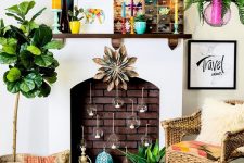 a colorful boho fireplace with candle bubbles inside, candle lanterns, potted plants, a colorful tapestry and bright planters