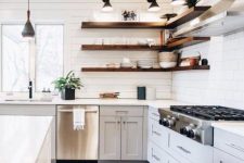 a dove grey farmhouse kitchen with white planked walls, dark stained floating shelves and black lamps